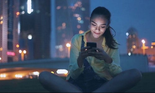 Student looking at her smart phone  