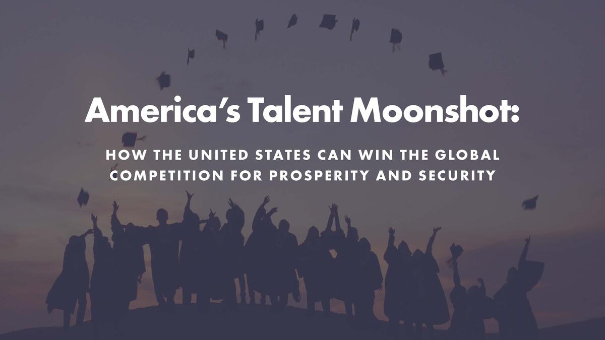 A group of graduates in shadow celebrate by throwing their mortar boards in the air. 