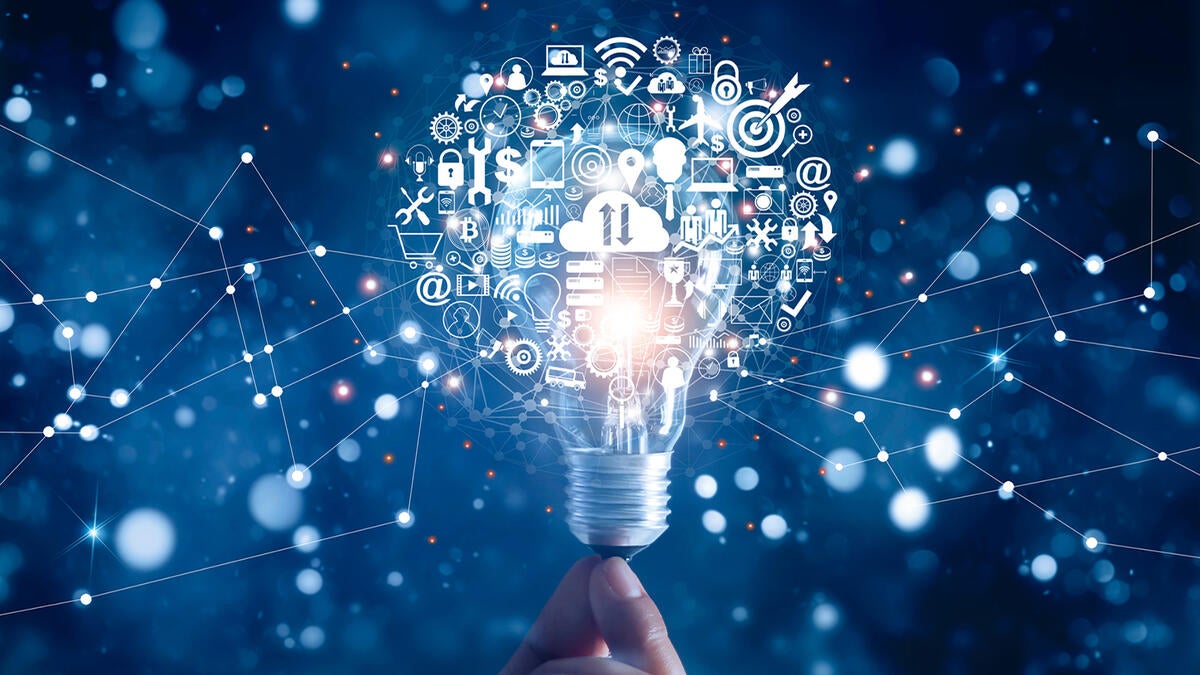 A hand holding up an imaginary lightbulb that is emitting images related to science and technology. 