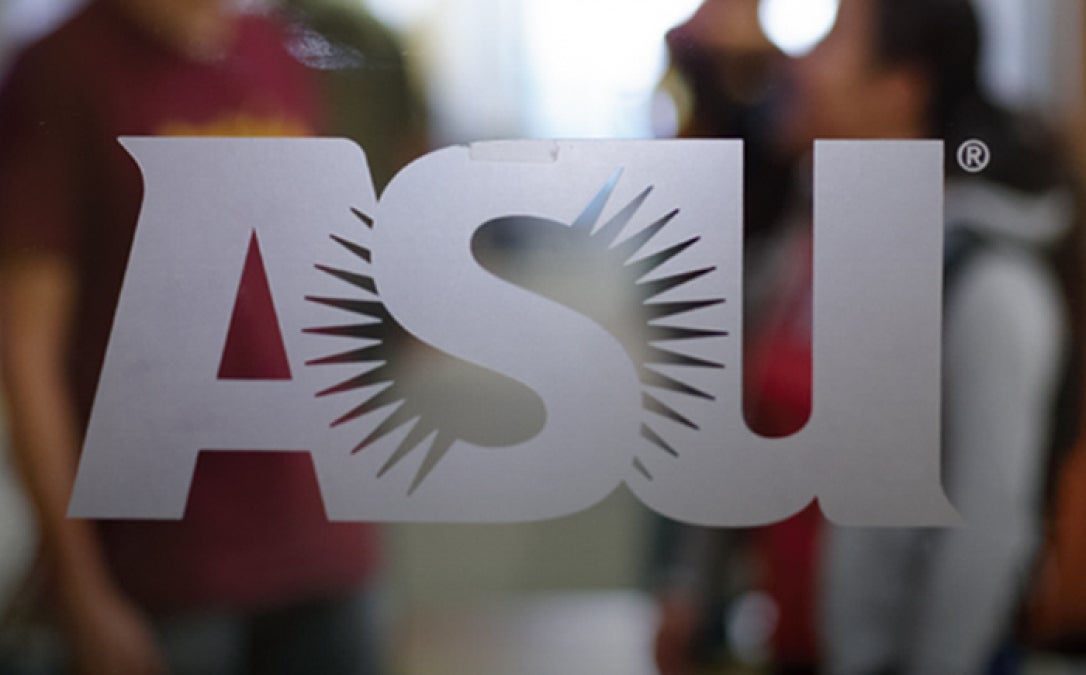 The ASU logo in frosted glass on a clear glass window. 