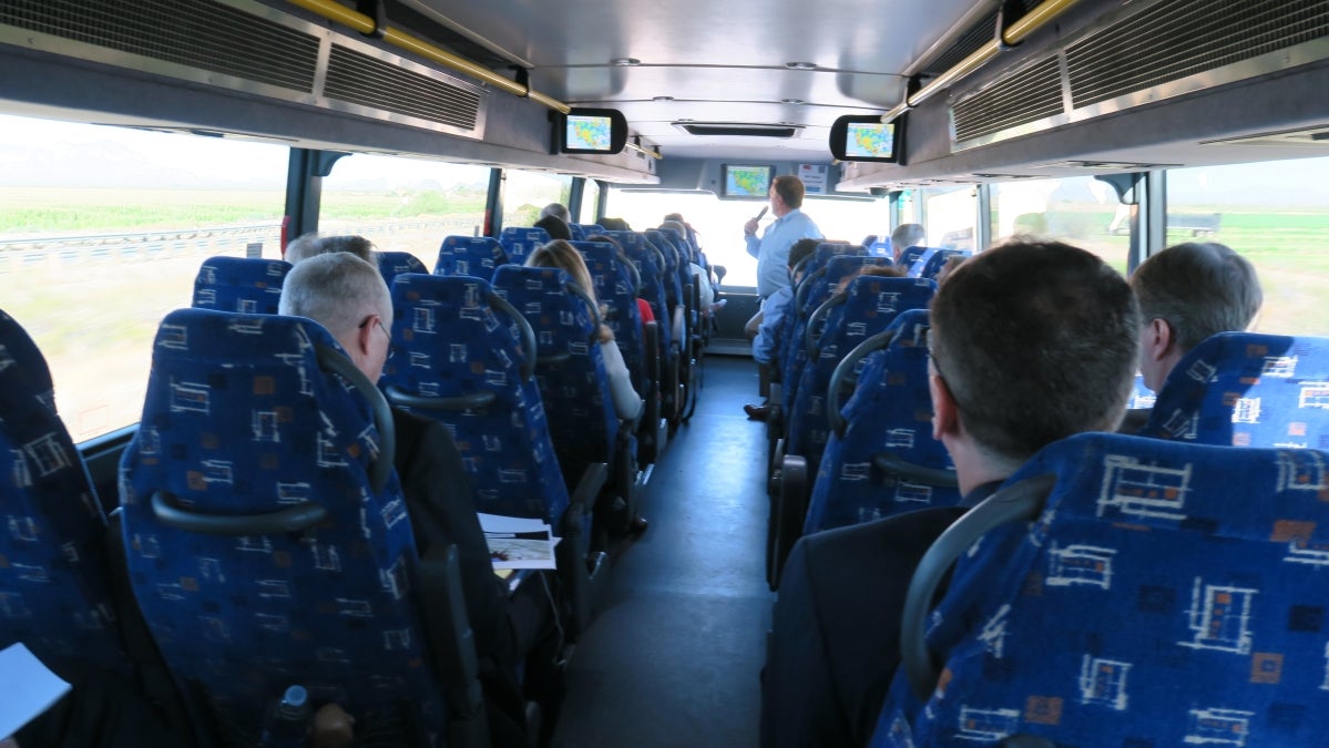 ASU President Crow presents to the ASU leadership team on a bus to Southern California