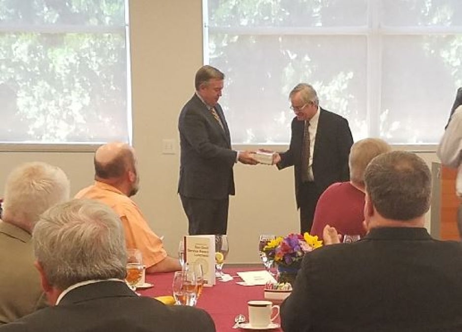 ASU President Michael Crow presents a Sun Devil Service Award