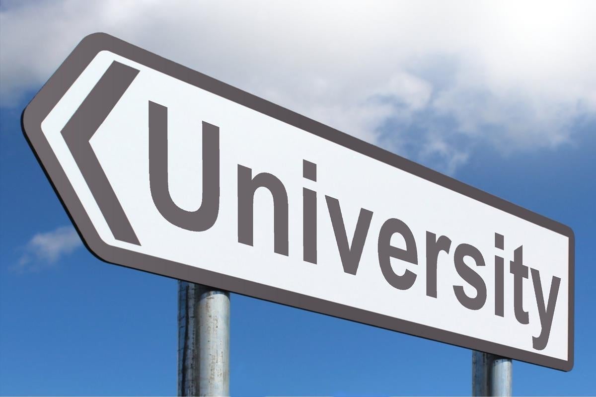 A European-style road sign reading "University" against a backdrop of a partly cloudy sky 