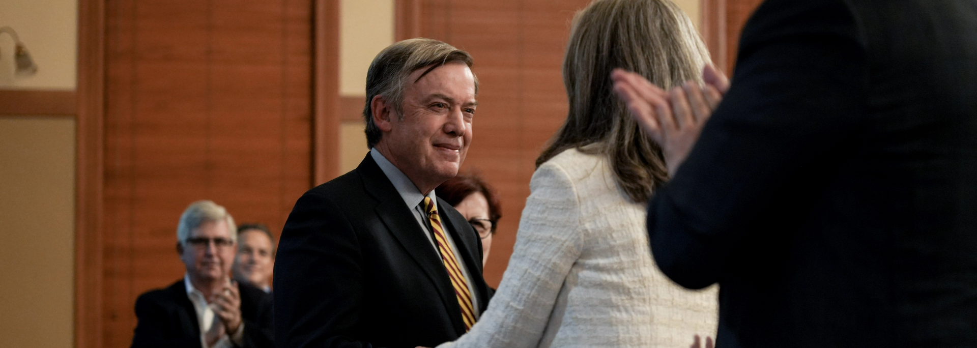 ASU President Michael Crow being congratulated
